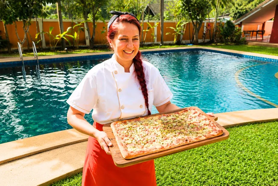 Chef Roberta with a Roman pizza by the pool